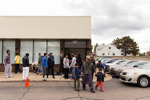 Macomb Muslims gather in front of a mosque after a prayer service