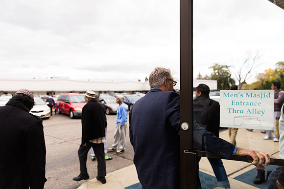 Rev. Michail Curro greets members of Macomb's Muslim community outside of a mosque
