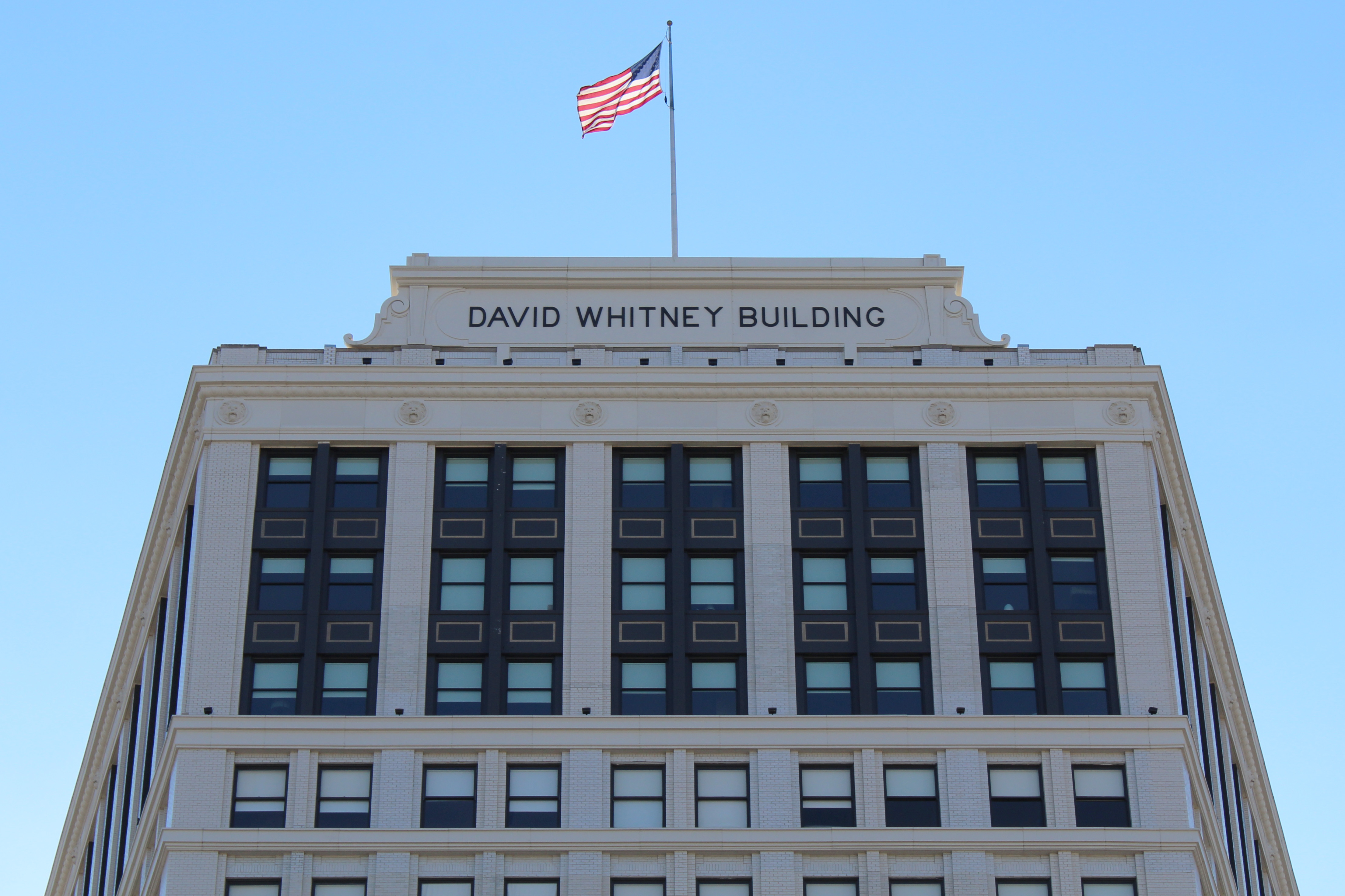 The David Whitney’s renovation include a cornice, pediment sign, and lions’ heads made by Glassline