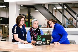 Katelyn Coberley, Bia Hamed, and Paulette Avolio work at Eastern Michigan University's Sill Hall.