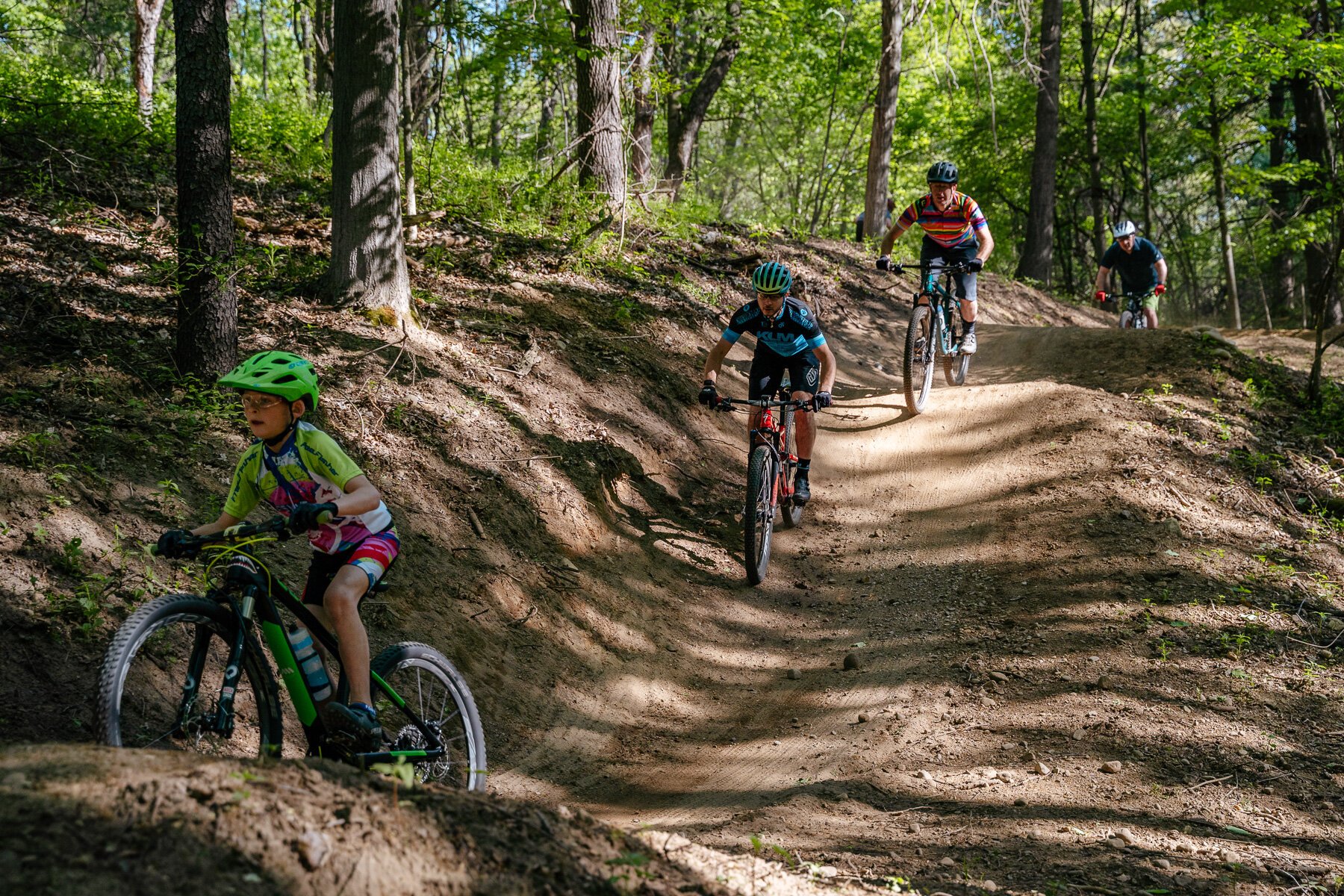 From left, Tyler and Adam Pokowski, Steve Vigneau, and Wade Robbins ride the Shelden Trails at Stony Creek Metropark.