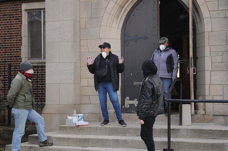 Water activists Debra Taylor and Monica Lewis-Patrick instruct volunteers on water delivery protocols on March 21, 2020, at St. Peter’s Episcopal church in Corktown. 