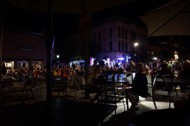 Beyond the stage, the night scene is abuzz. Downtown restaurants offer outdoor seating where diners can enjoy a locally-made delight.