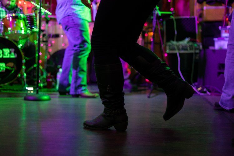 Patrons dance at a recent live show at 702 Bar