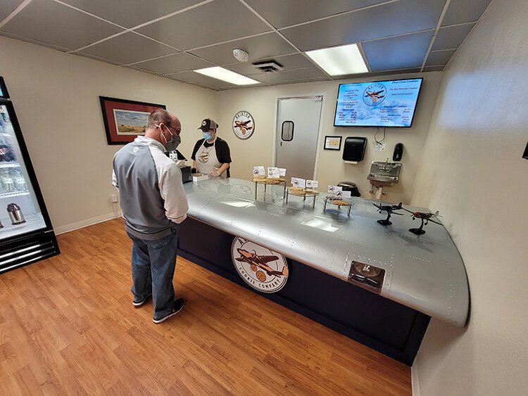 A section of an airplane wing serves as the counter at the Aviator Cookie Company in MIdland.