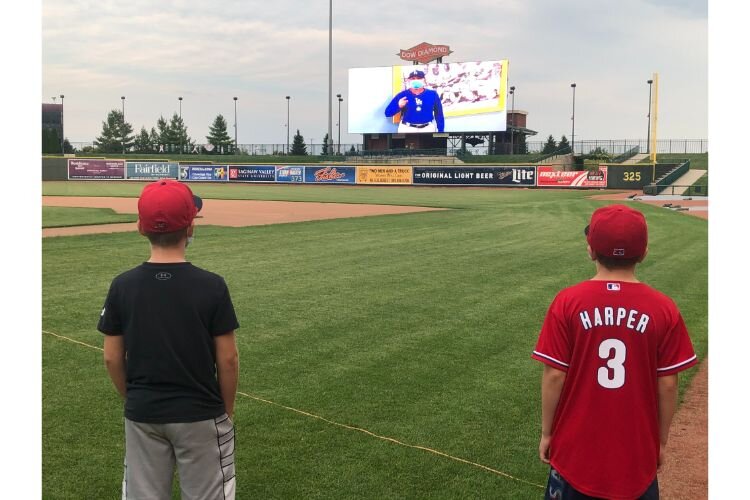 Two young boys listen to a personal message from general manager John Shoemaker.