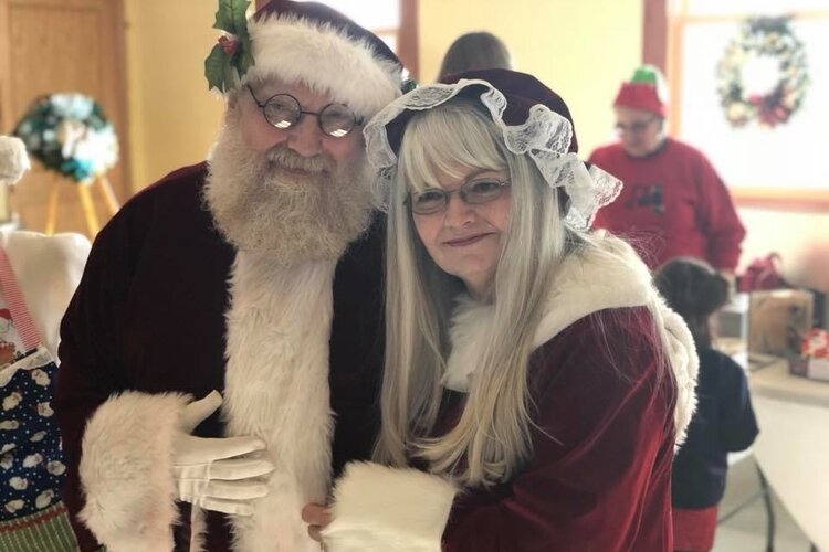 Children have the opportunity to meet and tell their Christmas wish list to Santa and Mrs. Claus at Christmas in Clare. Photo courtesy of the Clare Area Chamber of Commerce. 