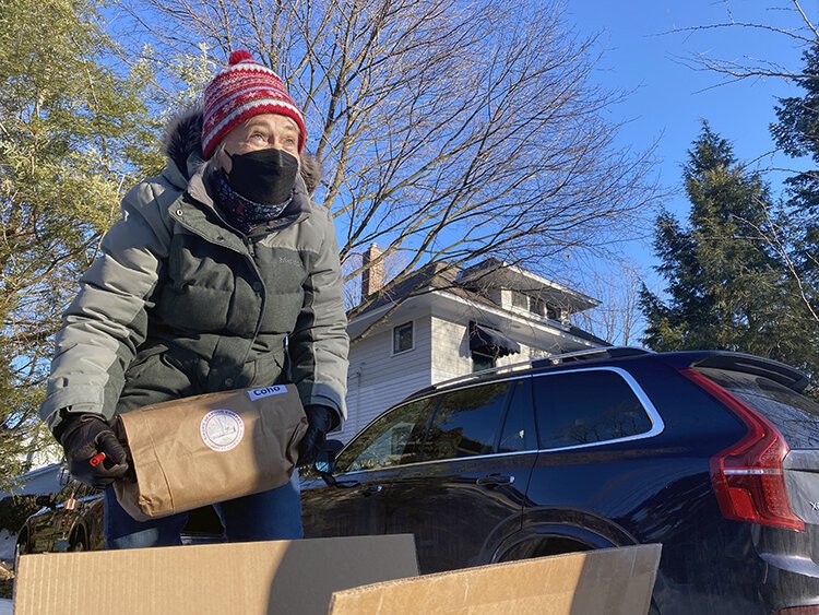 LoLita Pfeiffer picks an order of coho salmon. The most recent shipment also touted halibut, lingcod, prawns, shrimp, and cherry-hickory smoked salmon. 