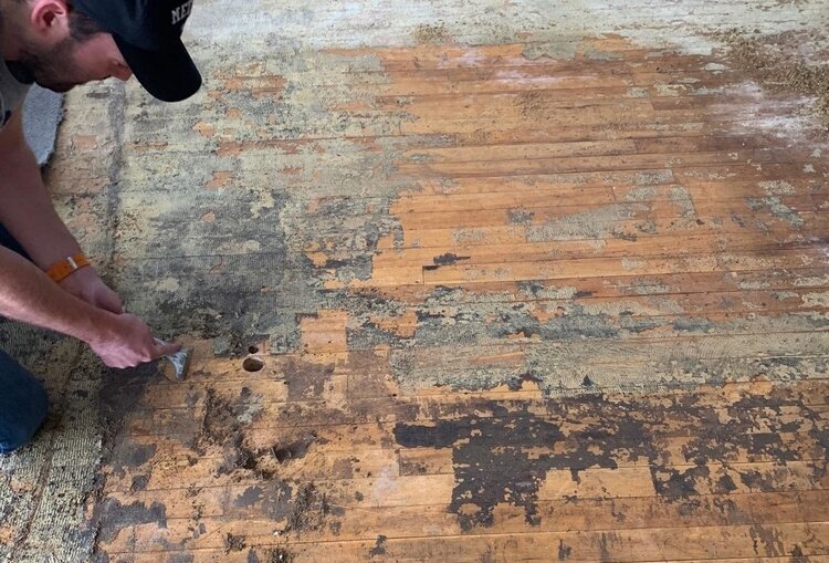 Getting down to the original wood floors.