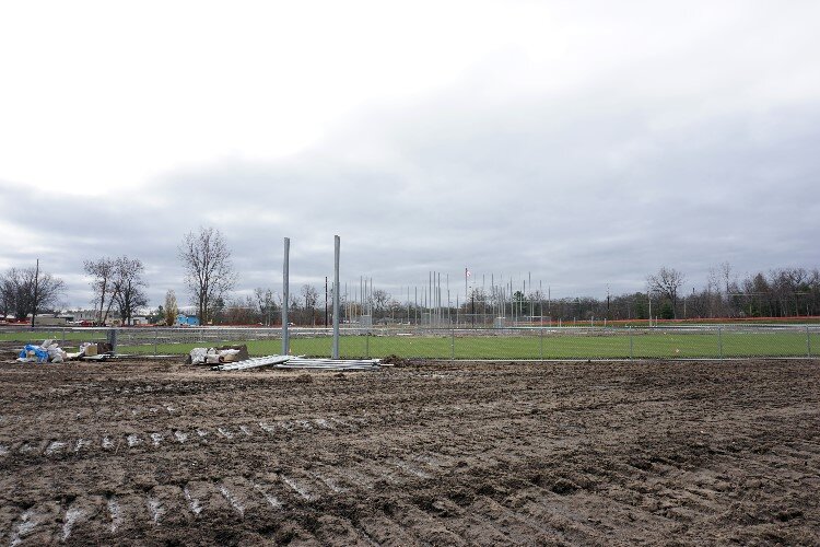 The grass seed arrived later than expected, but the growth enabled by the temperate fall weather has sports enthusiasts hopeful for a late spring start next year.