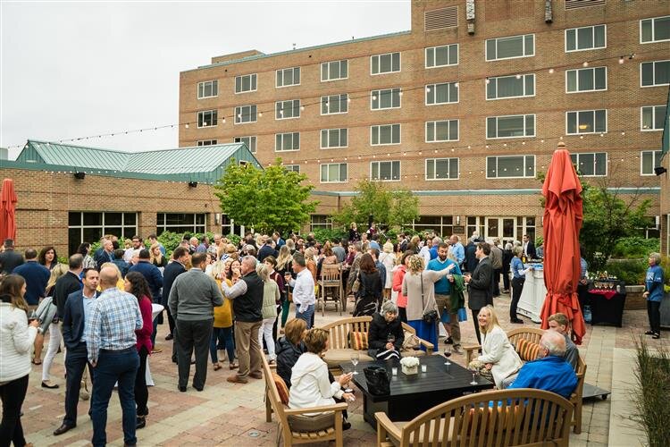 Guests gathering in the courtyard before the start of Dinner on Main.