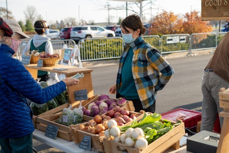 Sarah Longstreth of Good Stead Farm, masked-up in 2020, sells fresh produce including lettuce, salad greens, microgreens, garlic, tomatoes and carrots.