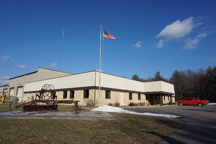 The Midland County Road Commission’s primary location is at 2334 N. Meridian Rd. in Sanford. A donated antique, horse-drawn gravel paver sits out front. 