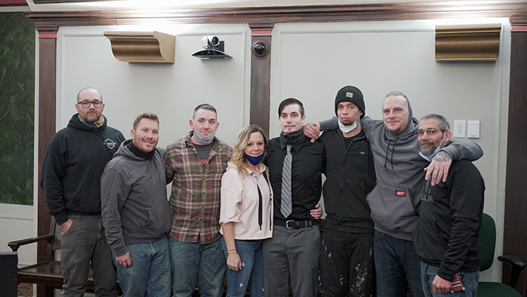 Wygant, center, is surrounded by friends and loved ones as he celebrates his graduation from the MiHOPE program.