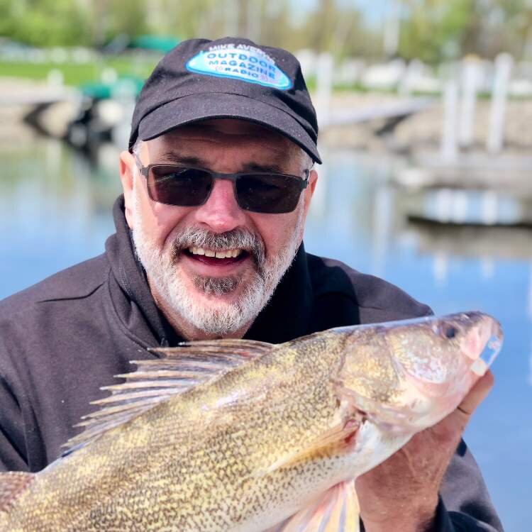 Mike Avery and his catch of the day, a walleye.
