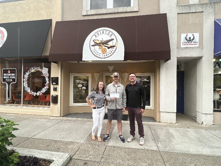 MYPros check presentation to Chris Welch of Aviator Cookie Company.