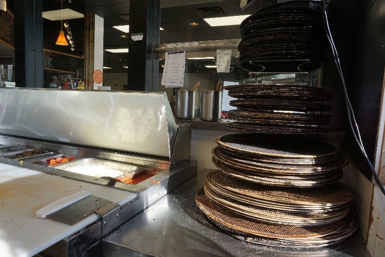 The pizza station overlooks the front entrance, so anyone curious can peek at the process.