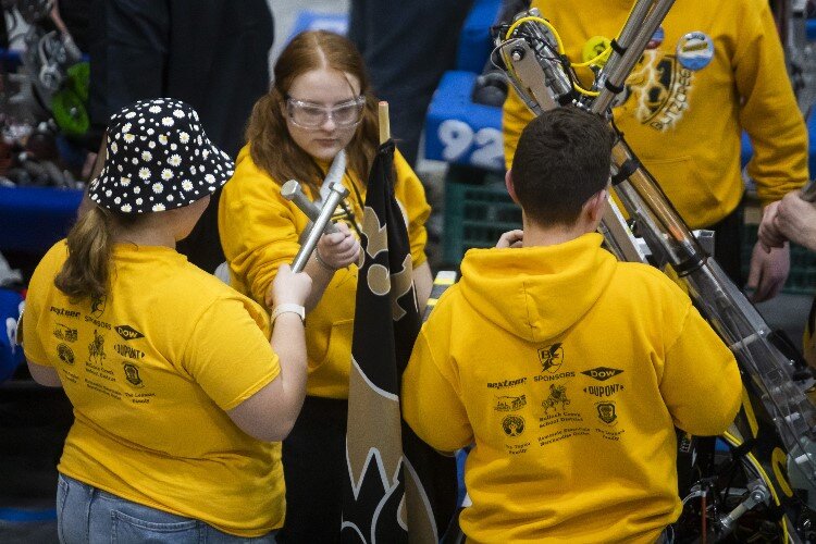 Members of "BlitzCreek" of Bullock Creek High School prepare to compete in a match during the FIRST.