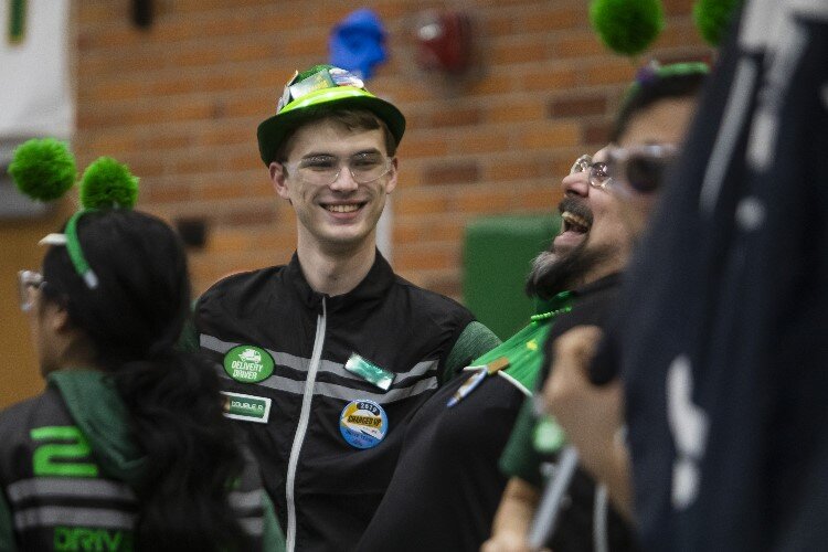 Dow senior Robert Roe chats with teammates on "The Charge" of Dow High School before competing in a match during the FIRST.