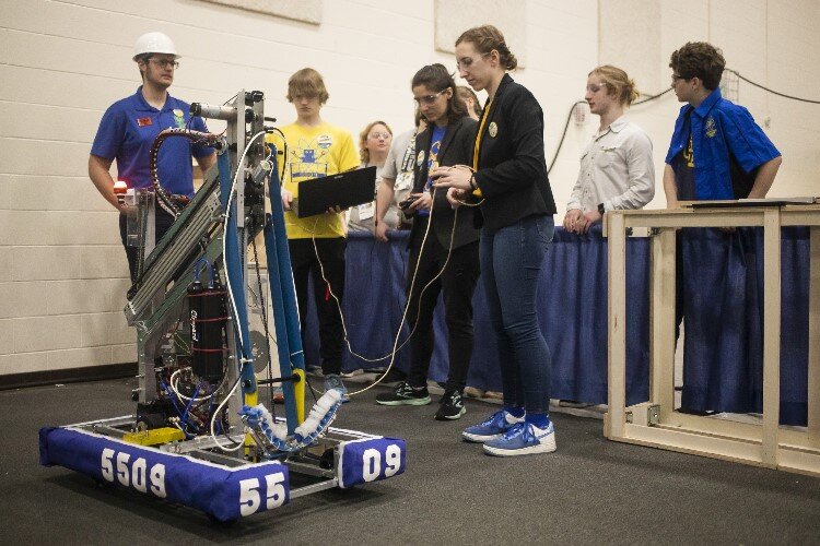 Team members of "Like a Boss" of Midland High School work on their robot.