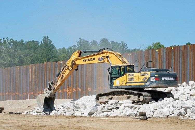 Between the steel sheet piling pounding and rock dumping, the construction site is a noisy place.