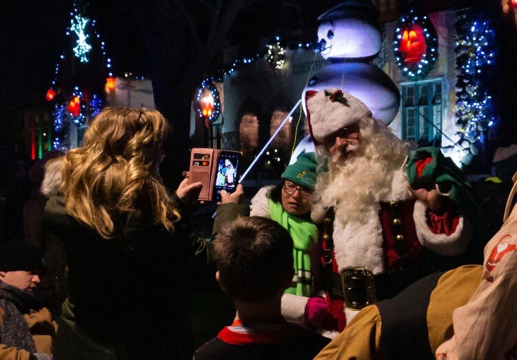 Santa and Mrs. Claus head for the Santa House, stopping for photos and saying “hi” along the way.