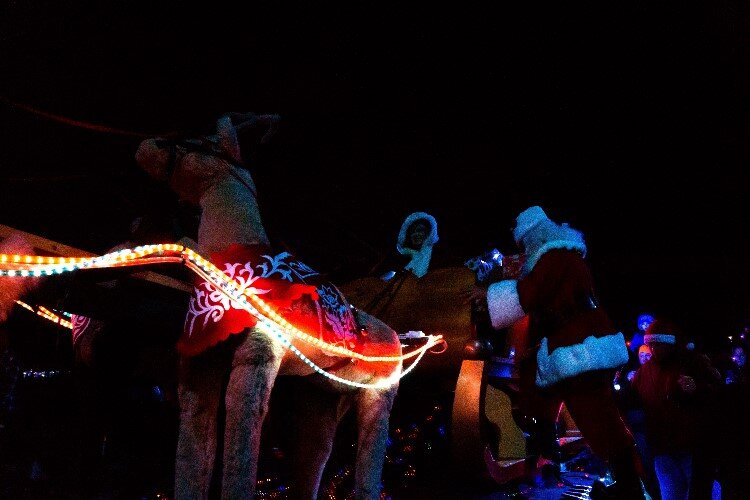 Mr. & Mrs.Claus hop aboard their sleigh to ride to the Midland County Courthouse for the ceremonial lighting.