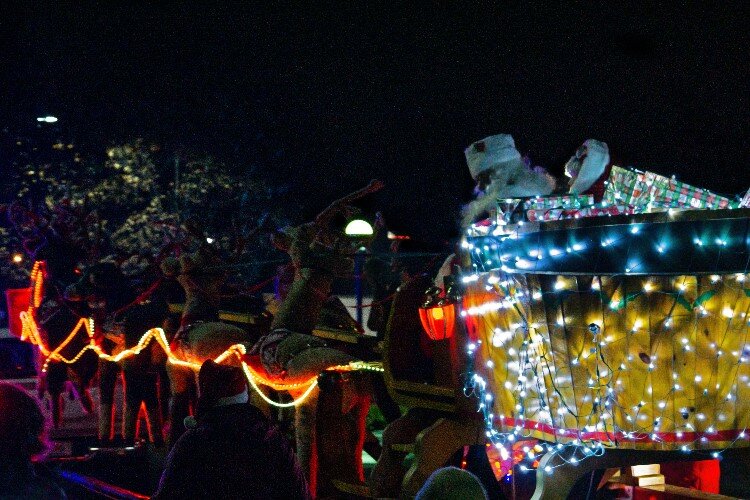 In honor of Rudolph leading the sleigh, the crowd sings, “Rudolph the Red-Nosed Reindeer.” Some shout out the extra, silly lyrics. 