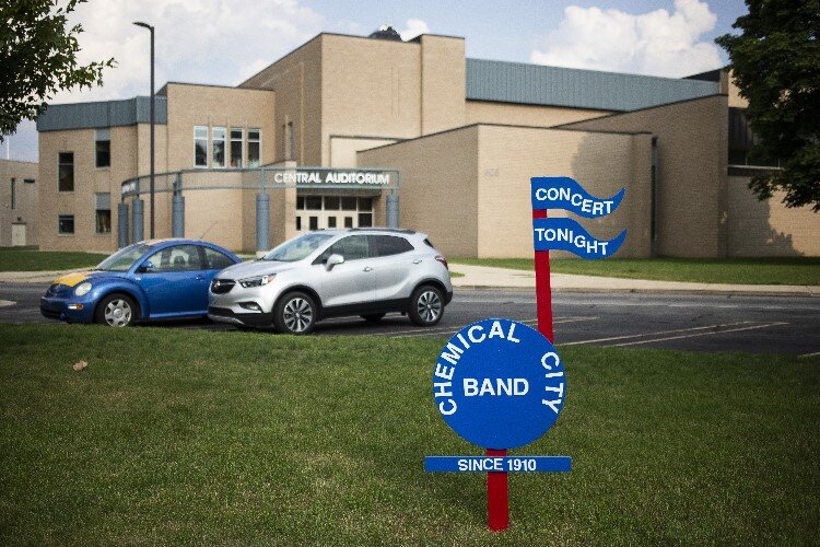A sign is posted in front of Central Auditorium ahead of the Chemical City Band's performance on July 5. The performance was moved from the usual location of the band shell in Midland’s Central Park due to weather concerns.