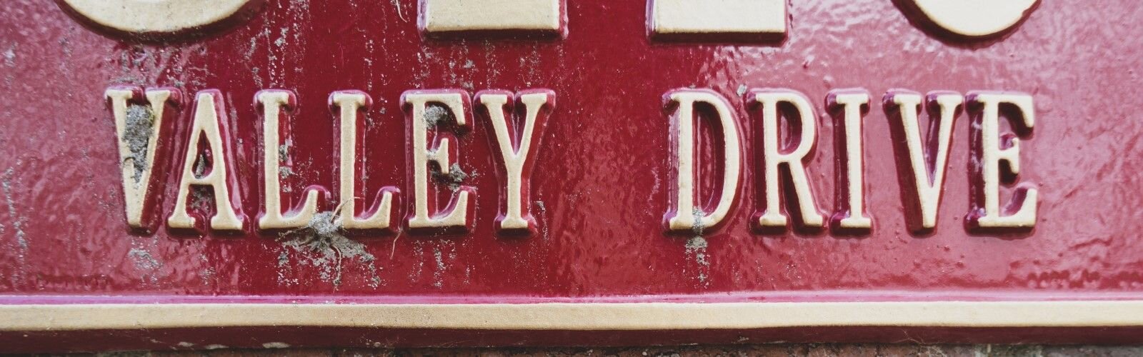 Remnants of the muddy flood waters can still be seen on the address sign.