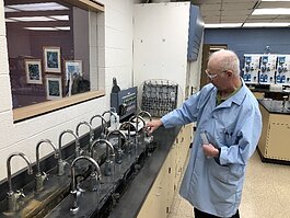 City employee at the water plant collects samples for testing.