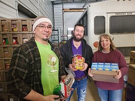 Hidden Harvest Food Delivery Specialist Tyler Hecht (center) making a delivery to the West Midland Family Center.