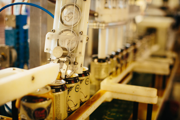 Cans being fitted with their lids.