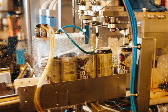 After the lids are sealed the cans go through a steamer water rinse and air dry process.