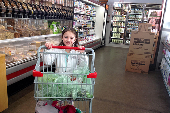 Mill Creek first grader Gracie Valdez shops for ingredients as part of a lesson on world food systems.