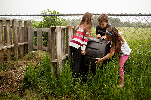 Second graders turn compost at Mill Creek Elementary as part of their gardening project.