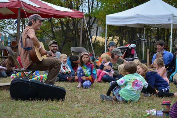 Chris Dorman plays near the kids tent.