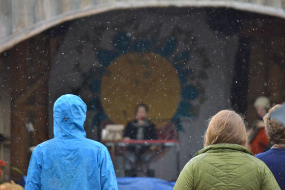 The hardiest of audience members wait out the rain.