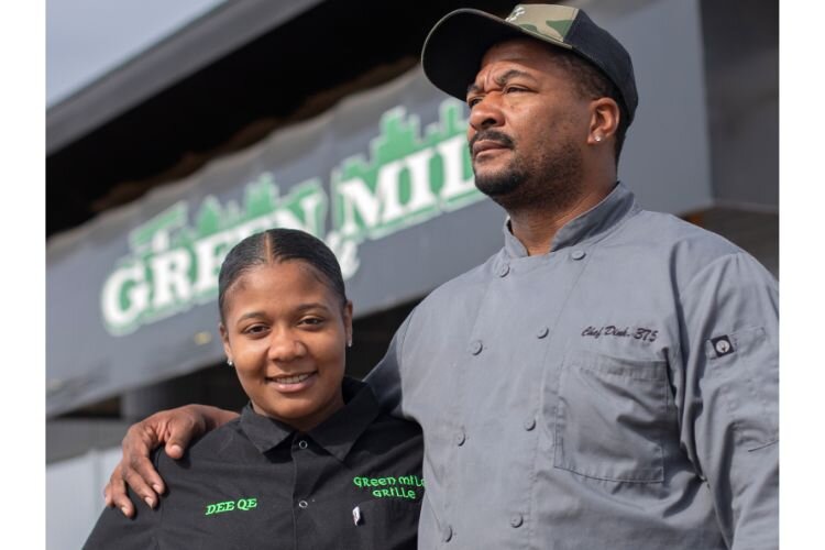 Program participant Chef Dink Dawson and his daughter in front of their restaurant, The Green Mile Grille in Detroit.