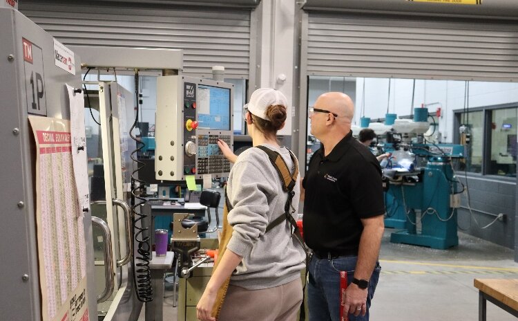 Aniah Jones trains on CNC machinery with teacher Steve Potter.