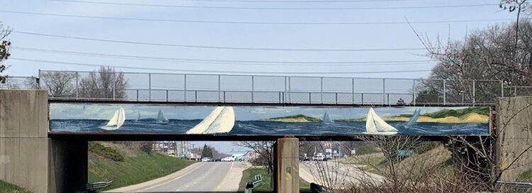 Jimmy Cobb completed his painting of the Norton Shores-Muskegon bridge in 2021. It is part of the MuskegonCity Public Art Initiative.