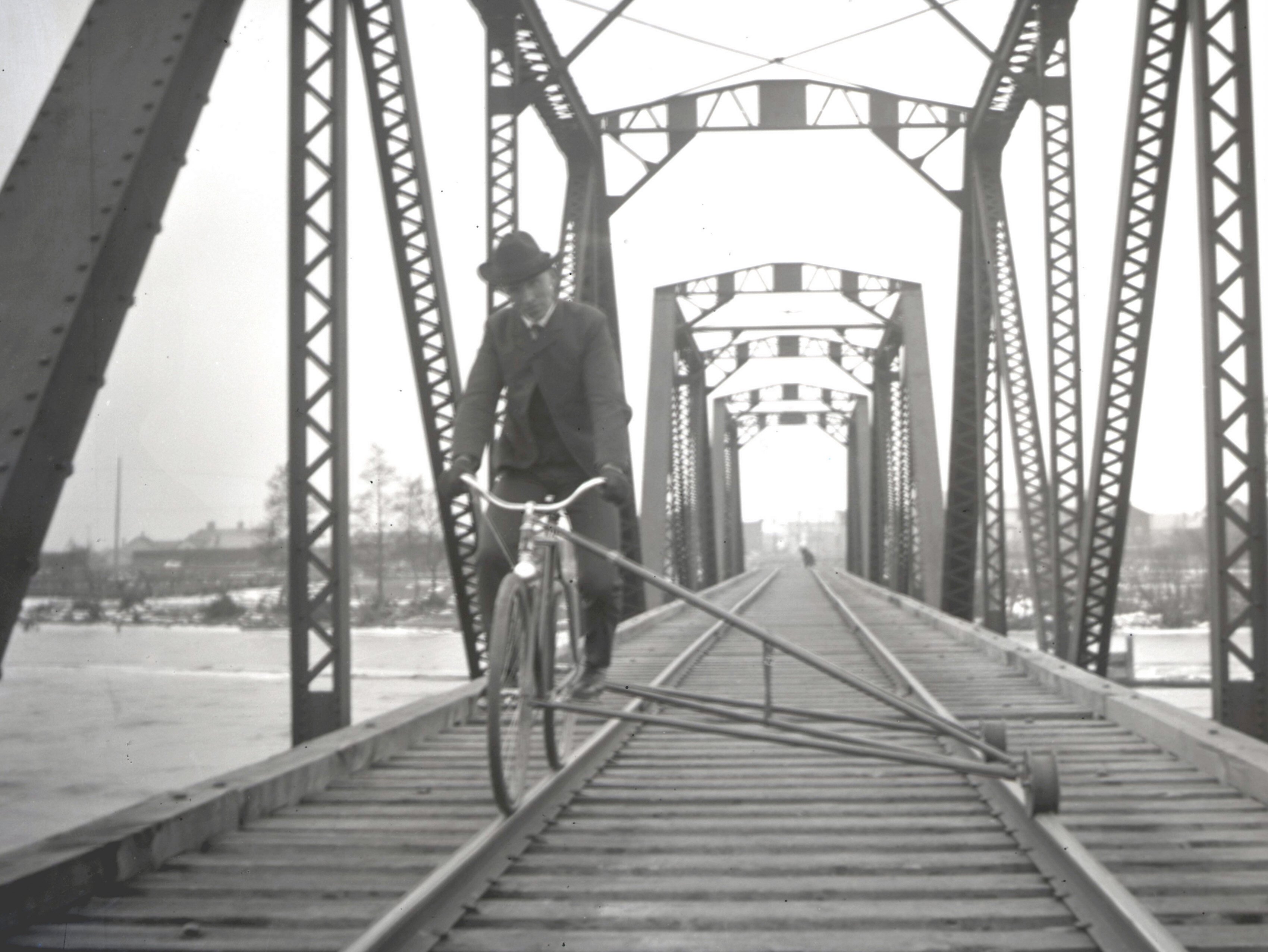 An unidentified man rides a railroad bike along the tracks in Manistique.