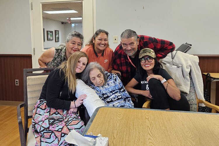 Siblings Irene Michels (top left), Maggie Toole (top middle), Alfonso Reyna (top right), and Edna Cooley (bottom right) pose for a photo with their mother Juanita Reyna (middle bottom) and Alfonso's daughter Rose (bottom left).