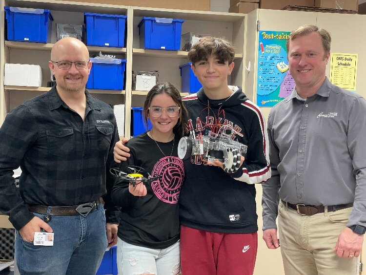 Shape's Dan Tlachac (left) and Scott Navarre (right) with students Sienna Eacker and Connor Arevalo at Oakridge Middle School. (Shape)