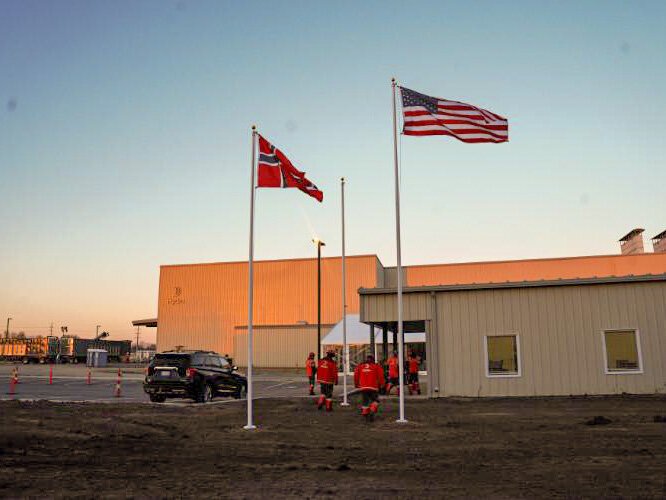 Raising the Norwegian and American flags at the new plant in Cassopolis.