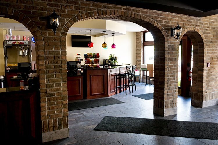 A wall once stood here, separating the lobby from the concession area. Now, these brick arches match other restored brick façade elements, bringing the exterior look in. 