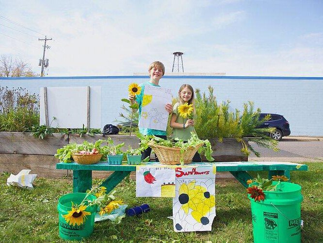 Students run a farm stand as part of Partridge Creek Farm's farm to school program in Ishpeming.