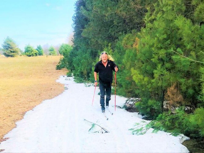 Pete Edwards cross-country skis at Sleeping Bear Dunes National Lakeshore. When there is no snow, he grabs his poles and hikes the dunes.