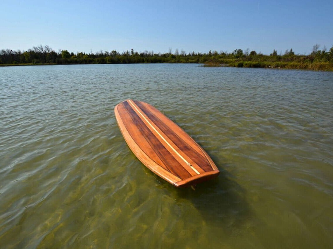 A paddleboard is tested in water.