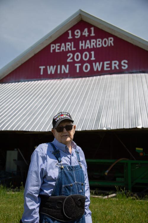 Ernest still farms and drives his pickup truck with his ever-faithful companion, a dog named Tiny, by his side.